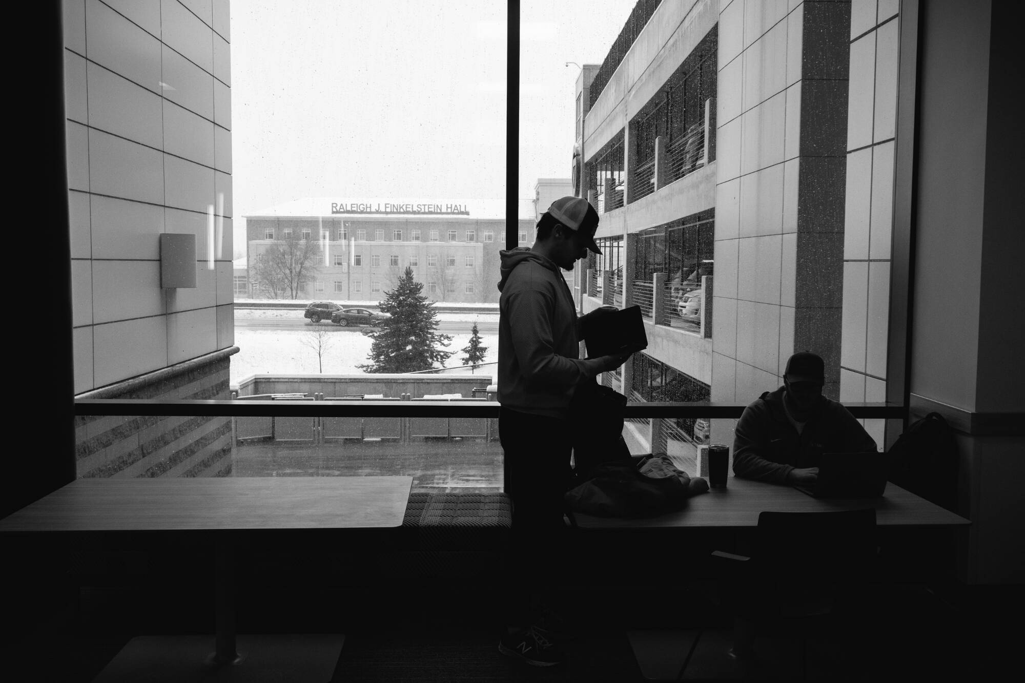 Black and white image of student studying in library